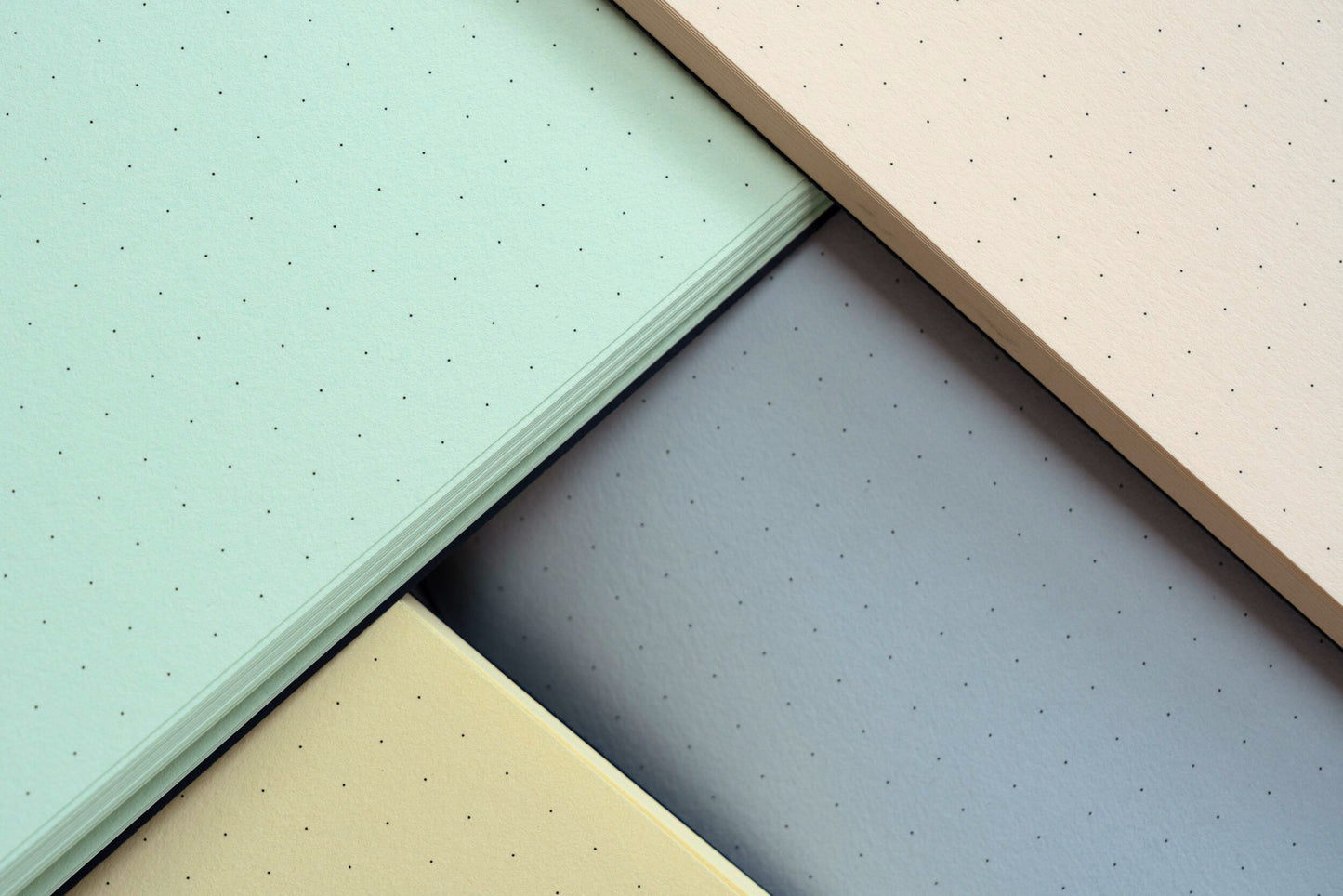 Four different colored textured sheets arranged in a pattern.