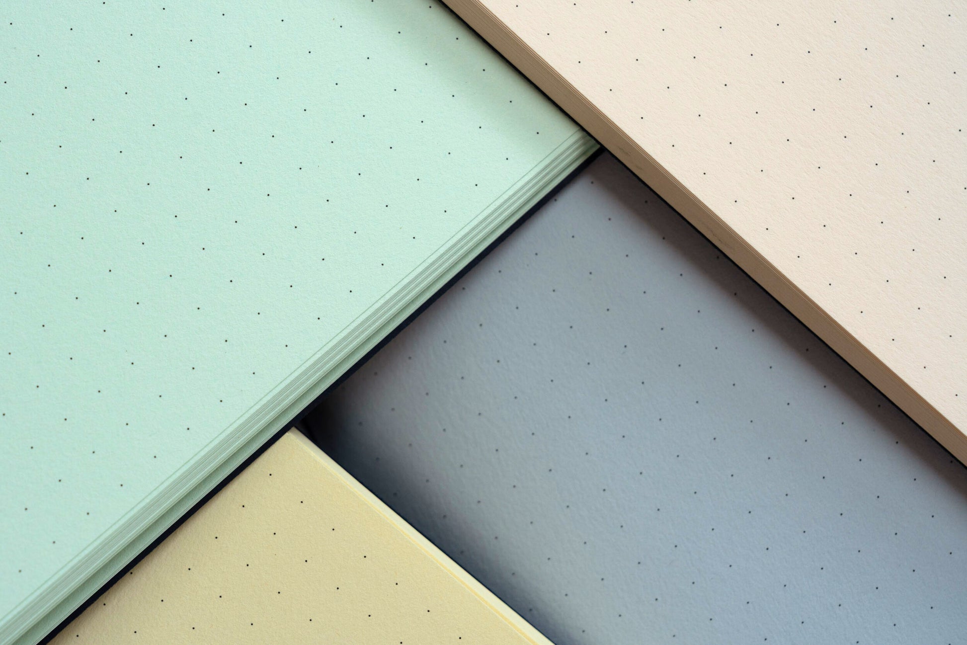 Four different colored textured sheets arranged in a pattern.